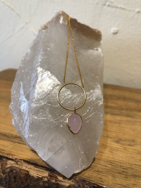 Gold necklace with ring and gemstone