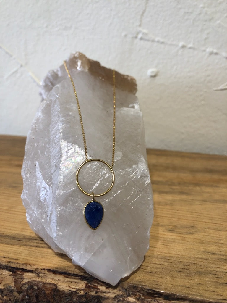 Gold necklace with ring and gemstone