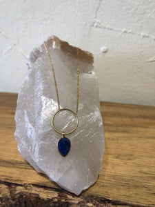 Gold necklace with ring and gemstone